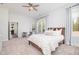 Bright bedroom with lots of natural light, neutral decor, and a full view of the outdoor landscape at 1515 Spring Overlook Ln, Hillsborough, NC 27278