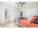 Bedroom featuring neutral walls, carpet, a ceiling fan, an open doorway, and a bed with dark accents at 1515 Spring Overlook Ln, Hillsborough, NC 27278