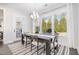 Bright dining room with modern chandelier and large windows overlooking greenery at 1515 Spring Overlook Ln, Hillsborough, NC 27278