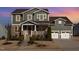 Charming two-story home featuring a stone facade, covered porch, and a two-car garage at 1515 Spring Overlook Ln, Hillsborough, NC 27278