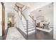 Elegant foyer featuring a staircase, hardwood floors, and an open view to the dining area at 1515 Spring Overlook Ln, Hillsborough, NC 27278