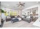 Bright living room with large windows, plush sofas, and an open layout to the kitchen at 1515 Spring Overlook Ln, Hillsborough, NC 27278