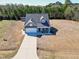 Aerial view showing home, driveway, and surrounding landscape at 1613 Osprey Ridge Dr, Willow Springs, NC 27592