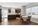 Bright kitchen features dark wood cabinets, an island, stainless steel appliances, and a cozy breakfast nook with natural light at 1613 Osprey Ridge Dr, Willow Springs, NC 27592