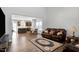 Open-concept living room and kitchen with hardwood floors, neutral paint colors, and plenty of natural light at 1613 Osprey Ridge Dr, Willow Springs, NC 27592