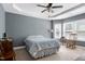 Comfortable bedroom featuring tray ceiling, neutral walls, and plenty of natural light at 1613 Osprey Ridge Dr, Willow Springs, NC 27592