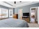 Spacious bedroom with large windows, a ceiling fan, and wood furnishings at 1613 Osprey Ridge Dr, Willow Springs, NC 27592
