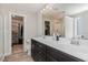 Dual-sink vanity in a bathroom with tile floors and walk-in closets on both sides at 19 Tobenton Ct, Clayton, NC 27520