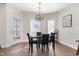 Bright dining area featuring stylish lighting fixture, table seating for four, and access to the backyard at 19 Tobenton Ct, Clayton, NC 27520
