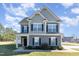 Charming two-story home featuring manicured lawn, beautiful architectural details, and inviting curb appeal at 19 Tobenton Ct, Clayton, NC 27520