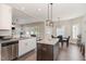 Well-lit kitchen features a dining area, granite countertops, stainless appliances, and a central island at 19 Tobenton Ct, Clayton, NC 27520