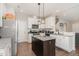 This well-lit kitchen features granite countertops, stainless appliances, and a central island at 19 Tobenton Ct, Clayton, NC 27520