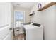 Convenient laundry room features modern appliances and shelving for storage at 19 Tobenton Ct, Clayton, NC 27520
