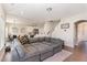 Open-concept living area showcasing a large sectional sofa, kitchen, and adjacent dining space at 19 Tobenton Ct, Clayton, NC 27520