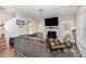 Comfortable living room with fireplace, neutral tones, large sectional, and ample natural light at 19 Tobenton Ct, Clayton, NC 27520