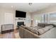 Cozy living room with a fireplace, large sectional sofa, and plenty of natural light at 19 Tobenton Ct, Clayton, NC 27520