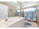 Bathroom featuring double sinks, large mirror, and a blue patterned shower curtain at 1945 Red Quartz Dr, Raleigh, NC 27610