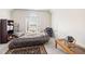 Cozy bedroom with natural light from a window, decorated with a blue chair and a globe on a wooden table at 1945 Red Quartz Dr, Raleigh, NC 27610