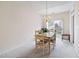 Bright dining area with light wood furniture and sliding glass doors to the exterior at 1945 Red Quartz Dr, Raleigh, NC 27610