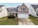 Charming two-story home with a two-car garage and neatly maintained front lawn at 1945 Red Quartz Dr, Raleigh, NC 27610