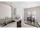Bright eat-in kitchen with white cabinets, light countertops, and stainless steel sink at 1945 Red Quartz Dr, Raleigh, NC 27610