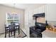 Eat-in kitchen featuring white cabinets, dark appliances, and pendant lighting above a dark wood dining table at 1945 Red Quartz Dr, Raleigh, NC 27610