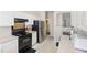 Kitchen with white cabinets, stainless steel appliances, and access to other rooms at 1945 Red Quartz Dr, Raleigh, NC 27610