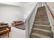Carpeted staircase leads to the living room with a fireplace and comfortable seating area at 1945 Red Quartz Dr, Raleigh, NC 27610
