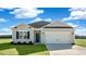 Charming single-story home with gray siding, a two-car garage, and a well-manicured lawn at 195 Hawksmoore Ln, Lillington, NC 27546