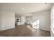 Open floorplan with wood-look floors and a kitchen featuring white cabinets and an island at 195 Hawksmoore Ln, Lillington, NC 27546