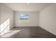 Inviting living area with wood-look floors and a large window to let in natural light at 195 Hawksmoore Ln, Lillington, NC 27546