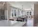 Open floorplan with view of dining room leading into the living room and stainless fridge at 2011 Trident Maple Ln, Chapel Hill, NC 27517