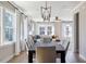 Bright dining room features a large window, modern lighting and flows into living room at 2011 Trident Maple Ln, Chapel Hill, NC 27517