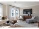 Bright and comfortable living room with large windows, modern TV and neutral color scheme at 2011 Trident Maple Ln, Chapel Hill, NC 27517