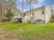 Spacious backyard featuring a deck and utility access, providing functionality and outdoor enjoyment at 204 Sugarland Dr, Apex, NC 27502