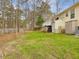 Lush backyard featuring a deck and storage shed, creating a versatile outdoor living space at 204 Sugarland Dr, Apex, NC 27502