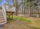 Expansive backyard featuring a raised deck, perfect for enjoying the natural surroundings and outdoor activities at 204 Sugarland Dr, Apex, NC 27502