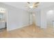Comfortable bedroom with ceiling fan, hardwood floors, closet and bath access, creating a peaceful retreat at 204 Sugarland Dr, Apex, NC 27502
