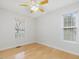 Bright, comfortable bedroom featuring hardwood floors, a ceiling fan, and a large window at 204 Sugarland Dr, Apex, NC 27502