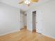 Bedroom with hardwood floors, ceiling fan, and closet, creating a relaxing atmosphere at 204 Sugarland Dr, Apex, NC 27502