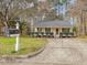 Quaint single-story home features manicured landscaping and a classic mailbox near the driveway at 204 Sugarland Dr, Apex, NC 27502