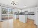 Modern kitchen featuring white cabinets, black countertops, and stainless-steel appliances at 204 Sugarland Dr, Apex, NC 27502