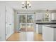 Eat-in kitchen featuring a sliding glass door to the deck and stainless steel sink at 204 Sugarland Dr, Apex, NC 27502