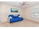 Neutral toned bedroom with blue futon, ceiling fan, and beachy art on the wall at 2418 Pecan Ridge Way, Apex, NC 27502