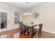 Cozy dining room with hardwood floors, chandelier lighting, and view to the backyard at 2418 Pecan Ridge Way, Apex, NC 27502