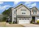 Charming two-story home featuring a gray exterior, attached garage, and well-maintained landscaping at 2418 Pecan Ridge Way, Apex, NC 27502