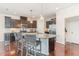 Spacious kitchen features stainless steel appliances, dark cabinetry, and granite countertops at 2418 Pecan Ridge Way, Apex, NC 27502