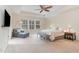 Main bedroom features a tray ceiling, ample natural light, and comfortable sitting area at 2418 Pecan Ridge Way, Apex, NC 27502