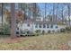 Spacious backyard with mature trees and a charming deck, perfect for relaxation at 256 Marilyn Cir, Cary, NC 27513