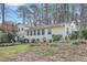 Lush backyard with mature trees and a charming deck, creating a tranquil outdoor space at 256 Marilyn Cir, Cary, NC 27513